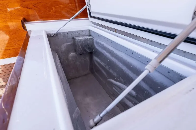 Shotgun Yacht Photos Pics Open storage compartment on 1981 Merritt 55 c boat, featuring wooden and metal details.