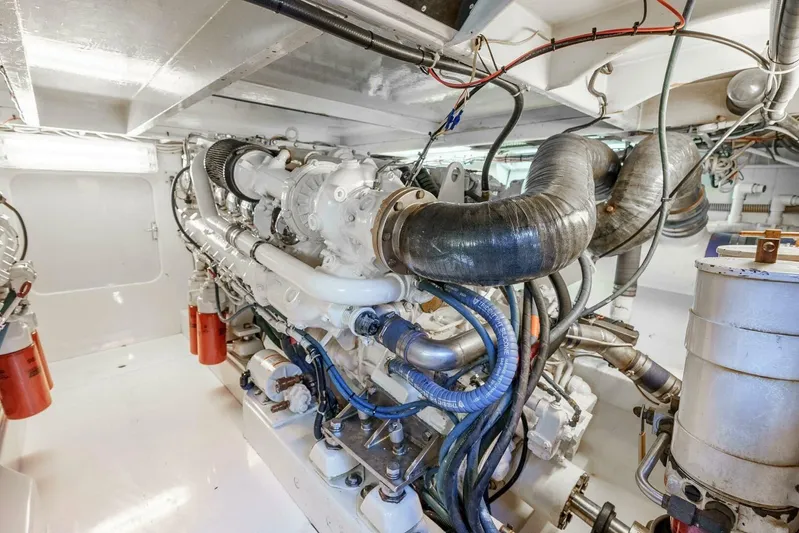 Shotgun Yacht Photos Pics Engine room of a 1981 Merritt 55 c boat, showcasing complex machinery and piping.