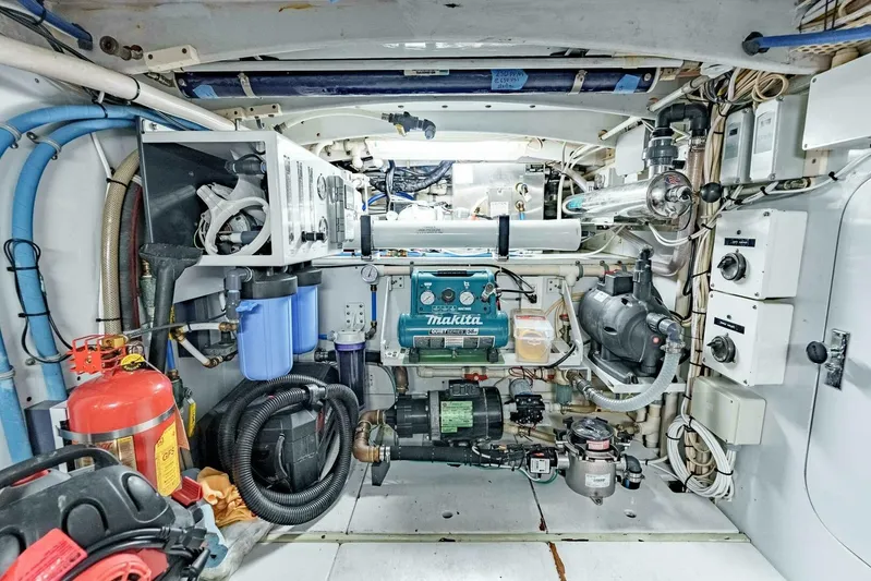 Shotgun Yacht Photos Pics Engine room of a 1981 Merritt 55 c boat, featuring various mechanical components.