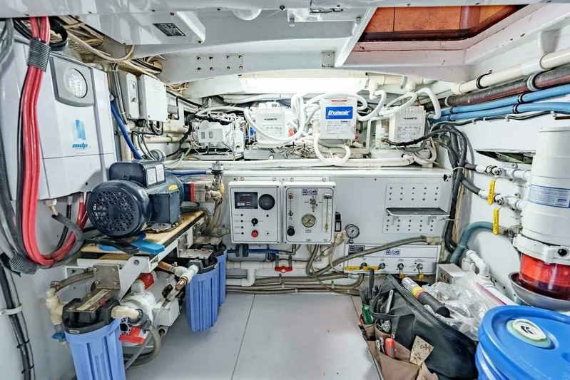 Shotgun Yacht Photos Pics Engine room of a 1981 Merritt 55 c boat, featuring various mechanical components and wiring.