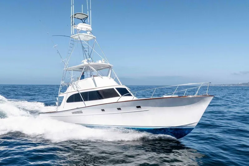 Shotgun Yacht Photos Pics 1981 Merritt 55 c yacht cruising on open sea under clear blue sky.