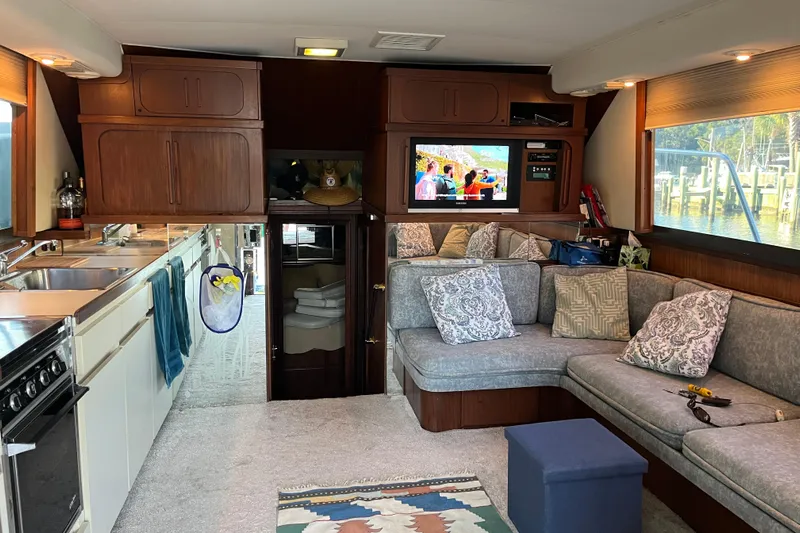 Moon Howler Yacht Photos Pics Interior of 1987 Hatteras 41 Convertible yacht with cozy seating and modern amenities.