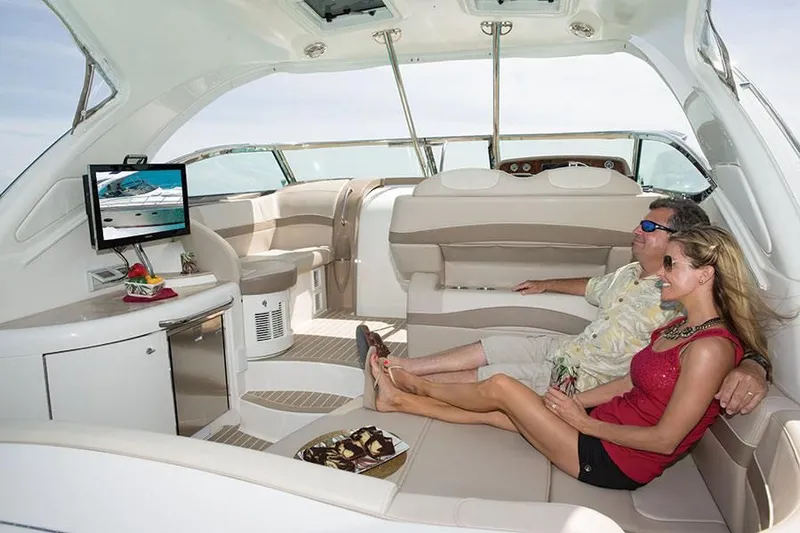 Anything For Me Too Yacht Photos Pics Couple relaxing on a 2014 Formula 37 Cruiser yacht interior.