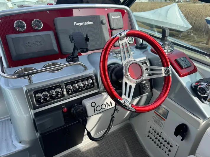 Anything For Me Too Yacht Photos Pics Cockpit of a 2014 Formula 37 Performance Cruiser with red steering wheel.