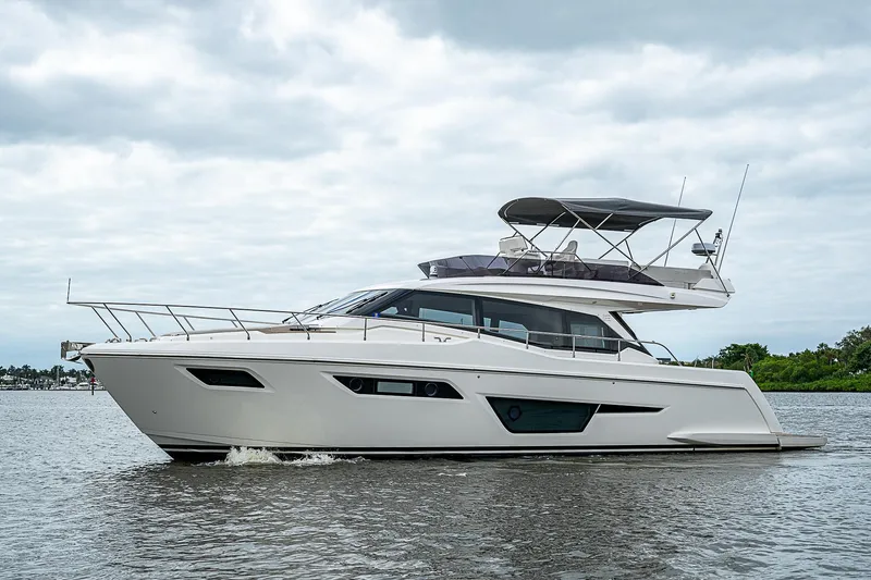 Time Chaser Yacht Photos Pics 2021 Ferretti Yachts 500 cruising on a calm waterway under cloudy skies.