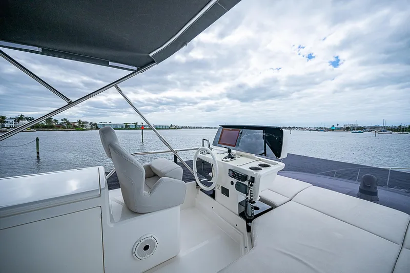 Time Chaser Yacht Photos Pics 2021 Ferretti Yachts 500 helm station with scenic water view.