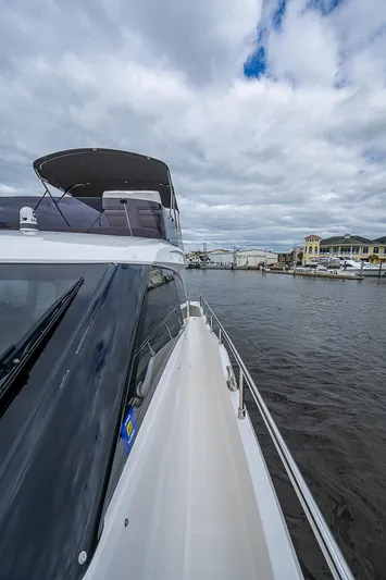 Time Chaser Yacht Photos Pics 2021 Ferretti Yachts 500 cruising on a cloudy day near a marina.