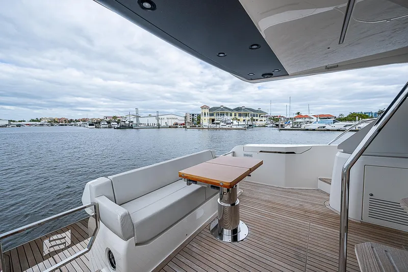Time Chaser Yacht Photos Pics Luxurious 2021 Ferretti Yachts 500 deck with seating, overlooking marina.