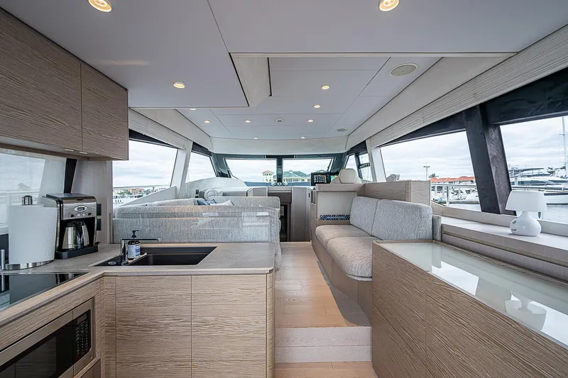 Time Chaser Yacht Photos Pics Luxurious interior of 2021 Ferretti Yachts 500, featuring modern kitchen and seating area.