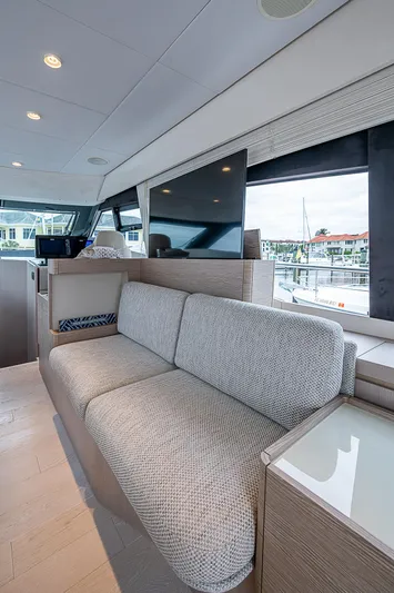 Time Chaser Yacht Photos Pics Luxurious interior of 2021 Ferretti Yachts 500 with modern seating and large windows.