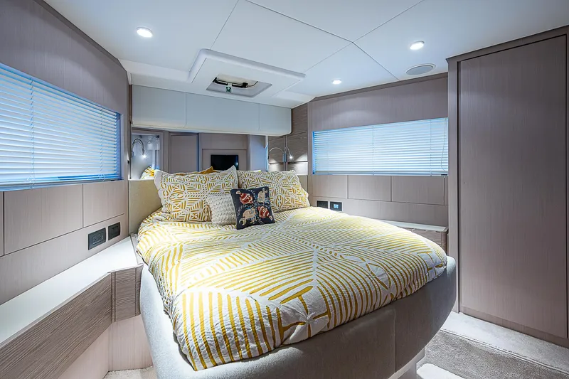 Time Chaser Yacht Photos Pics Luxurious bedroom interior of 2021 Ferretti Yachts 500 with modern design and cozy bedding.