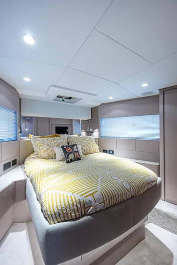 Time Chaser Yacht Photos Pics Luxurious bedroom interior of 2021 Ferretti Yachts 500 with modern design and cozy bedding.