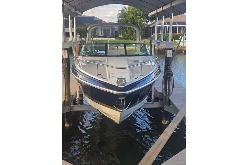Fly Me Yacht Photos Pics 2013 Formula 310 Sun Sport boat docked under a covered lift.