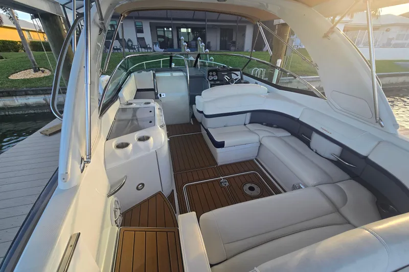 Fly Me Yacht Photos Pics 2013 Formula 310 Sun Sport boat interior with luxurious seating and wooden flooring.