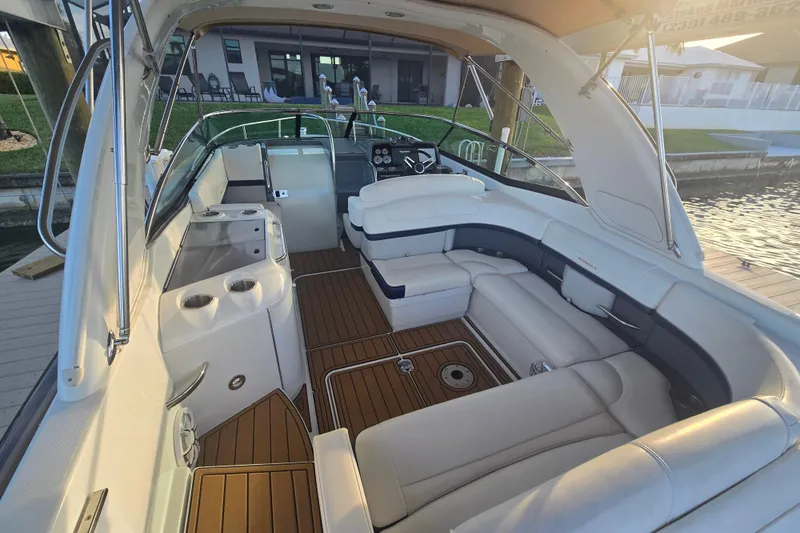 Fly Me Yacht Photos Pics 2013 Formula 310 Sun Sport boat interior with luxurious seating and wooden flooring.