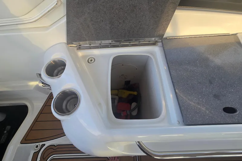 Fly Me Yacht Photos Pics 2013 Formula 310 Sun Sport boat interior with storage compartment and cup holders.