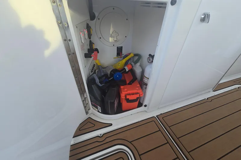 Fly Me Yacht Photos Pics Storage compartment on a 2013 Formula 310 Sun Sport boat with various supplies.