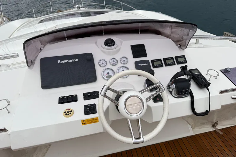  Yacht Photos Pics Cockpit of 2016 Prestige 620S yacht with Raymarine navigation system and steering wheel.