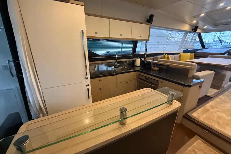  Yacht Photos Pics Luxurious interior of a 2016 Prestige 620S yacht featuring a modern kitchen and seating area.