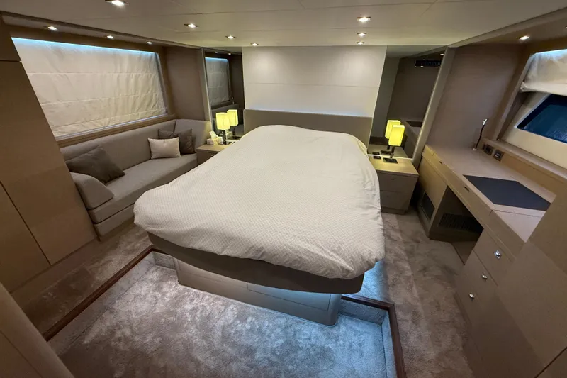  Yacht Photos Pics Luxurious bedroom interior of 2016 Prestige 620S yacht with modern furnishings and ambient lighting.