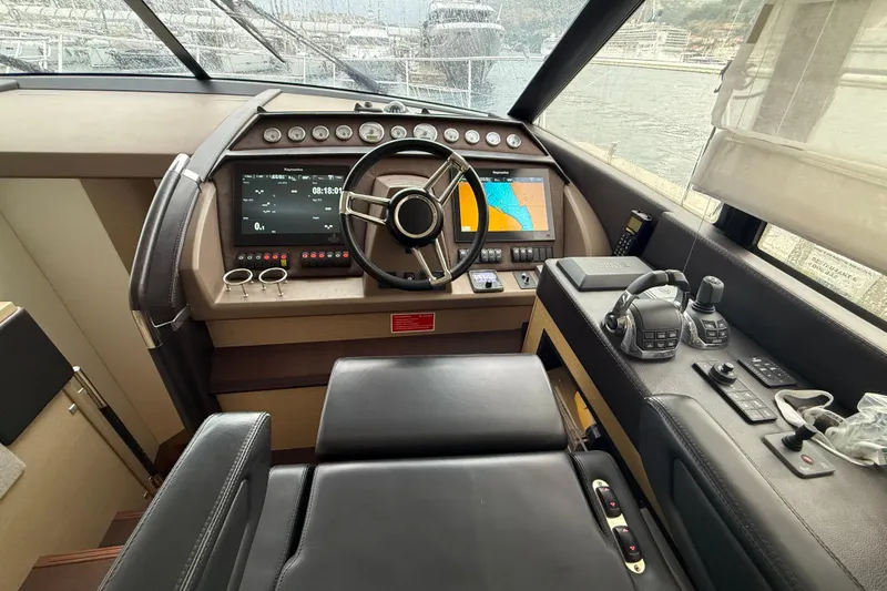  Yacht Photos Pics Cockpit of 2016 Prestige 620S yacht with navigation controls and steering wheel.