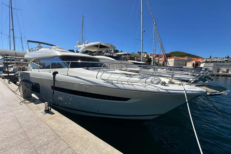  Yacht Photos Pics Luxury 2016 Prestige 620S yacht docked in a sunny marina setting.