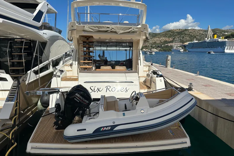  Yacht Photos Pics Luxury 2016 Prestige 620S yacht docked with tender boat, scenic harbor view.