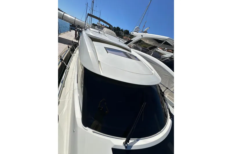  Yacht Photos Pics Prestige 620S yacht, 2016 model, docked under clear blue sky.