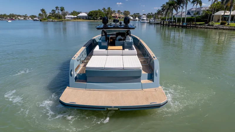 Available Now Yacht Photos Pics 2025 Pardo Yachts 50 cruising on a serene, palm-lined waterway.