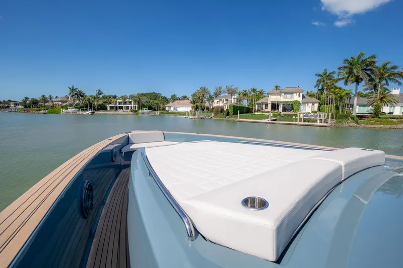 Available Now Yacht Photos Pics Luxurious 2025 Pardo Yachts 50 cruising near waterfront homes under clear blue skies.