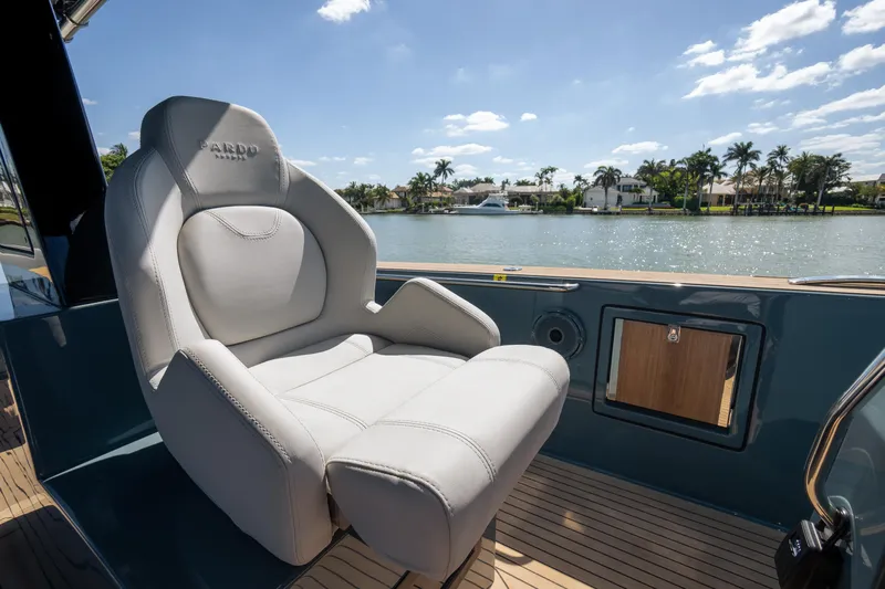Available Now Yacht Photos Pics Luxury seating on 2025 Pardo Yachts 50, overlooking serene waterfront and palm trees.