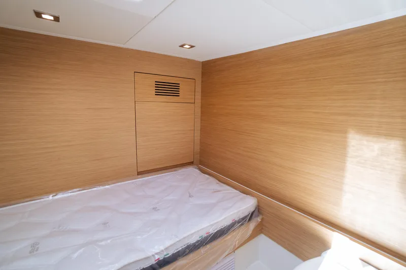 Available Now Yacht Photos Pics Interior cabin of 2025 Pardo Yachts 50 with wooden paneling and bed.