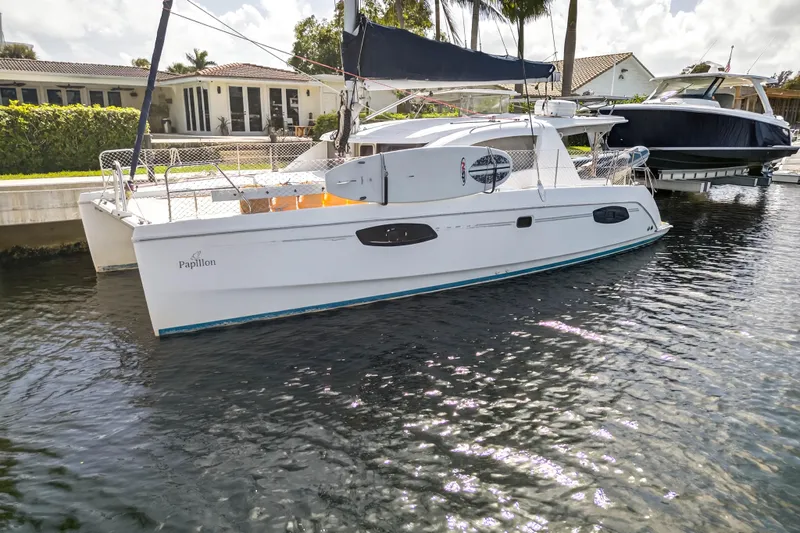 Papillon Yacht Photos Pics 2012 Leopard 39 catamaran docked in a sunny marina setting.