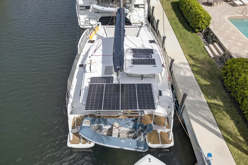 Papillon Yacht Photos Pics Overhead view of a 2012 Leopard 39 catamaran with solar panels docked by a pool.