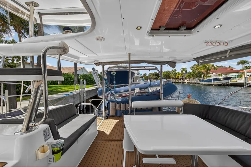 Papillon Yacht Photos Pics 2012 Leopard 39 yacht interior with seating and table, docked by a canal.