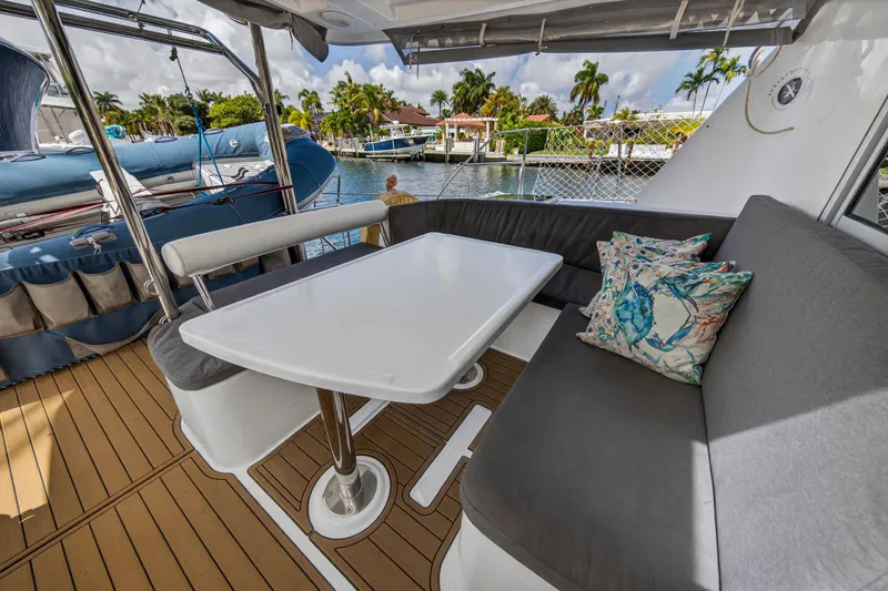 Papillon Yacht Photos Pics Outdoor seating area on a 2012 Leopard 39 yacht with table and cushions.