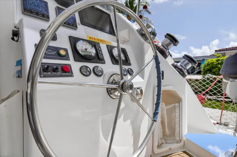 Papillon Yacht Photos Pics Steering wheel and controls of a 2012 Leopard 39 yacht, featuring gauges and winches.