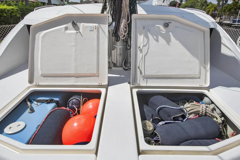 Papillon Yacht Photos Pics Open storage compartments on a 2012 Leopard 39 boat, containing ropes and safety equipment.