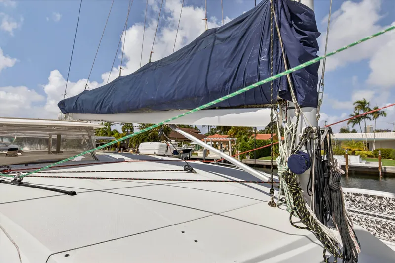 Papillon Yacht Photos Pics 2012 Leopard 39 sailboat deck with rigging and covered sail, docked near palm trees.