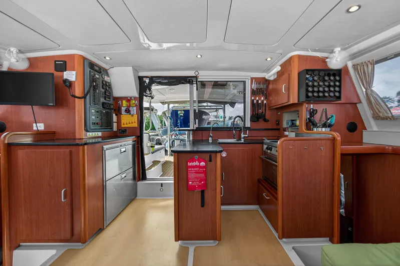 Papillon Yacht Photos Pics Interior of 2012 Leopard 39 yacht kitchen with wood cabinetry and modern appliances.