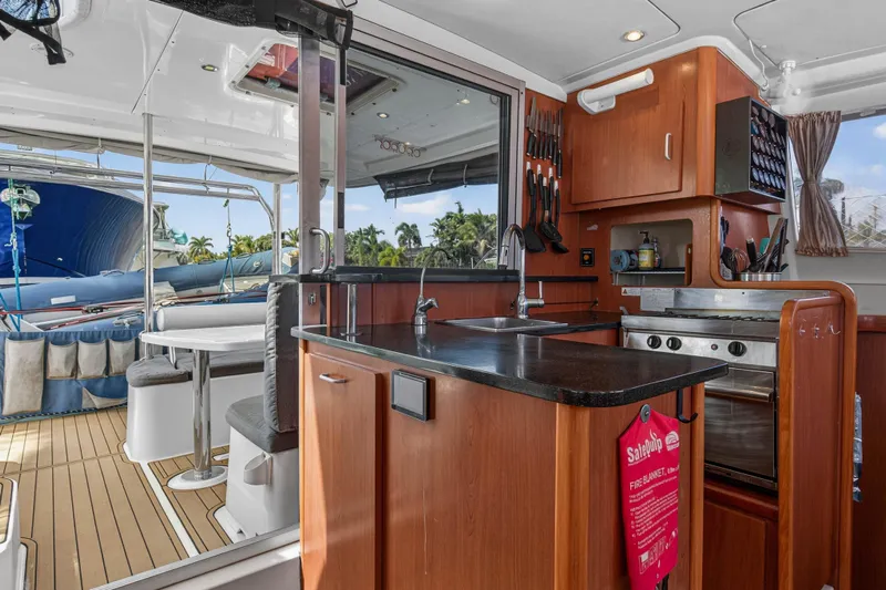 Papillon Yacht Photos Pics Interior of 2012 Leopard 39 yacht featuring kitchen and dining area with outdoor view.