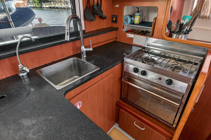 Papillon Yacht Photos Pics Galley kitchen in 2012 Leopard 39 yacht with stove, sink, and utensils.