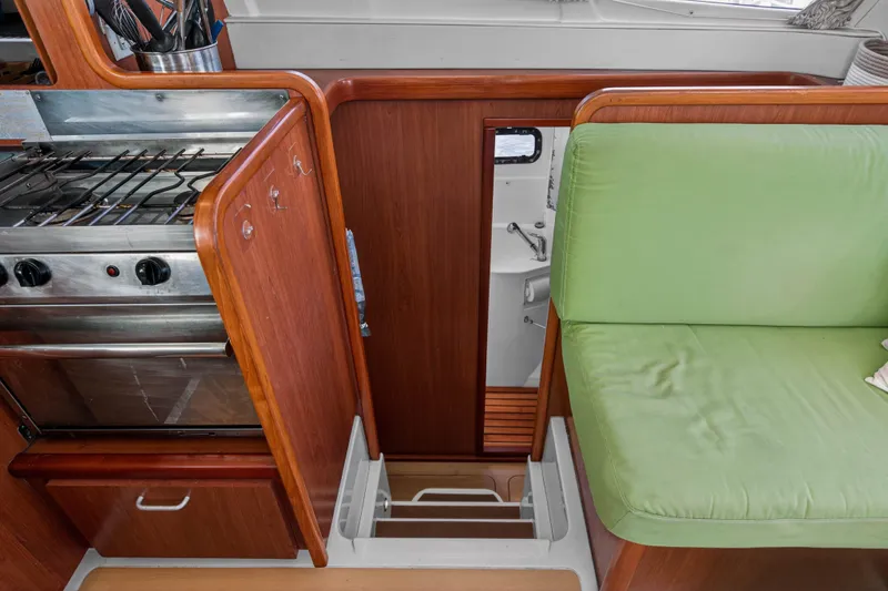 Papillon Yacht Photos Pics Interior of 2012 Leopard 39 yacht with green seating and compact kitchen area.