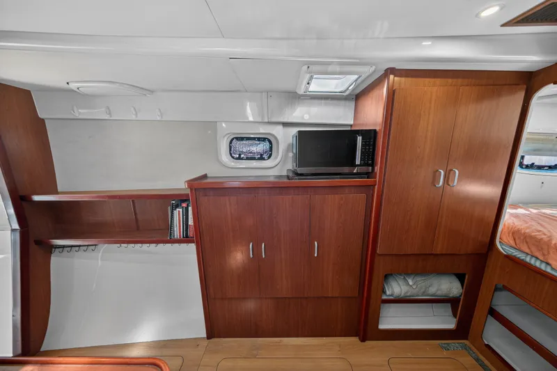 Papillon Yacht Photos Pics Interior of a 2012 Leopard 39 yacht with wooden cabinetry and a microwave.