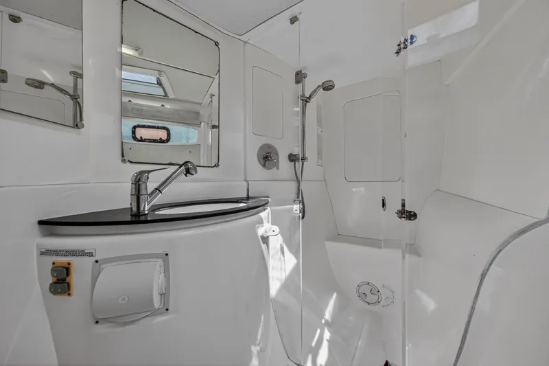 Papillon Yacht Photos Pics Modern bathroom in a 2012 Leopard 39 yacht, featuring sleek fixtures and ample lighting.