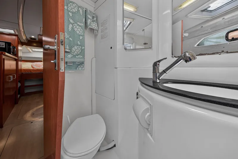 Papillon Yacht Photos Pics Interior of 2012 Leopard 39 yacht bathroom with sink, toilet, and cabin view.