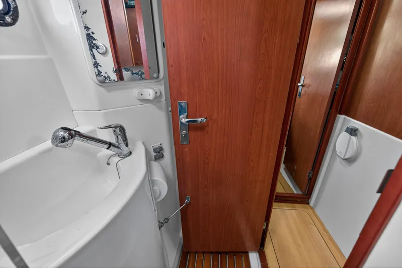Papillon Yacht Photos Pics Bathroom interior of a 2012 Leopard 39 yacht, featuring a sink and wooden door.