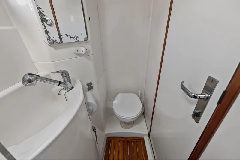 Papillon Yacht Photos Pics Compact bathroom in a 2012 Leopard 39 yacht, featuring a toilet, sink, and mirror.