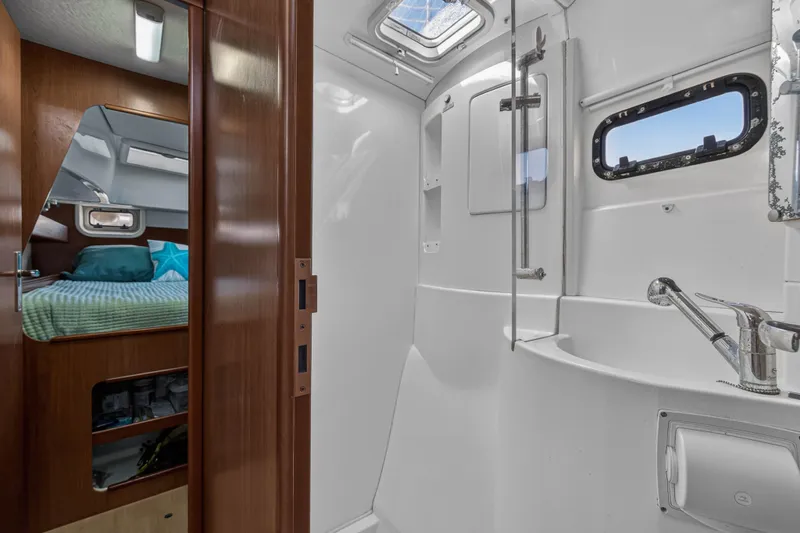 Papillon Yacht Photos Pics Interior of 2012 Leopard 39 yacht showing bathroom and adjacent bedroom.