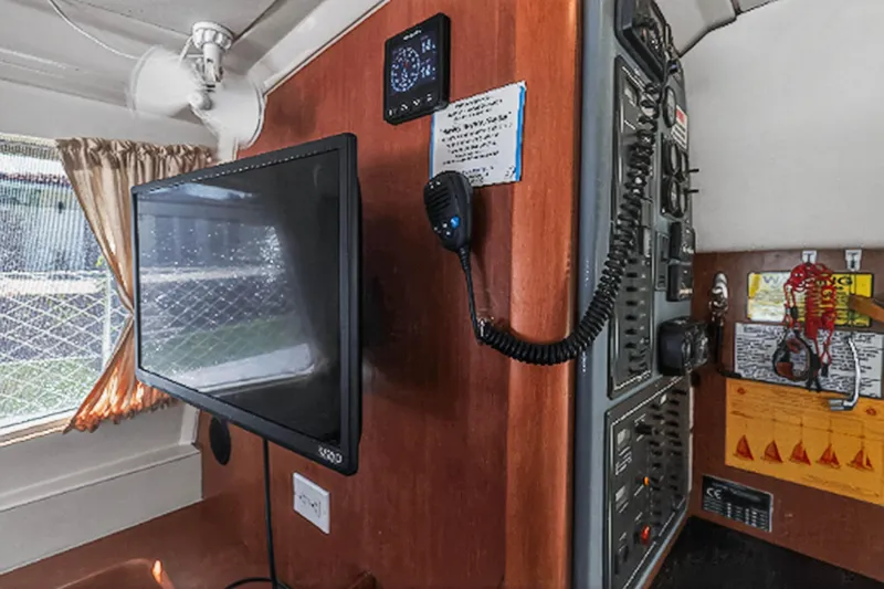 Papillon Yacht Photos Pics Interior of 2012 Leopard 39 yacht with control panel and mounted TV.